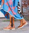 A woman wearing a dress and Kataleya boots by Bed Stu.