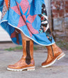 A woman wearing a dress and Kataleya boots by Bed Stu.