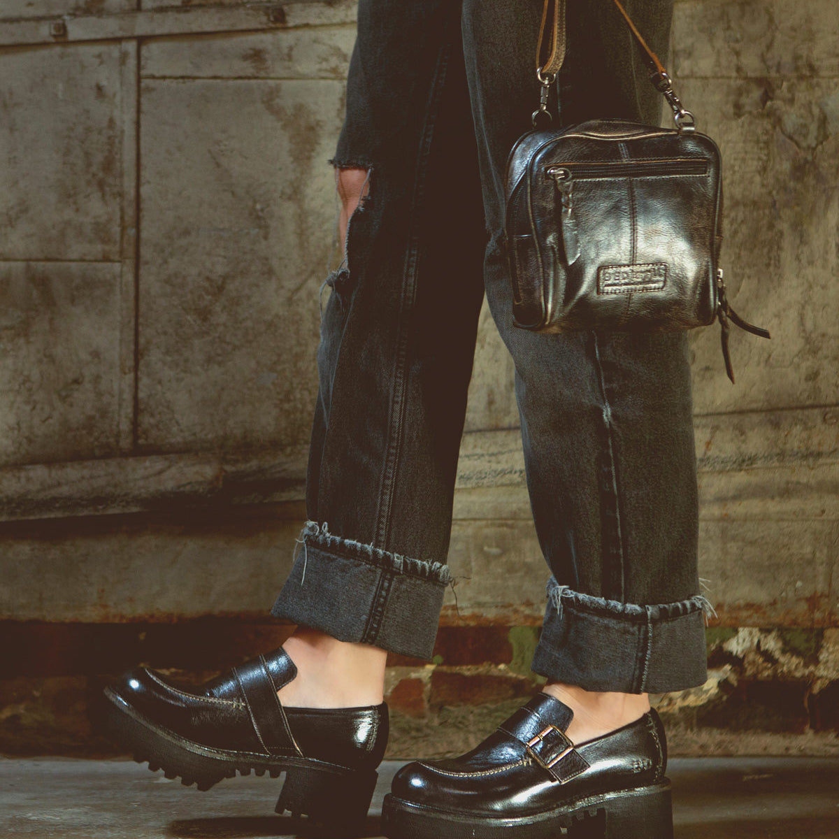 A woman wearing Kavi black jeans and Bed Stu leather loafers.