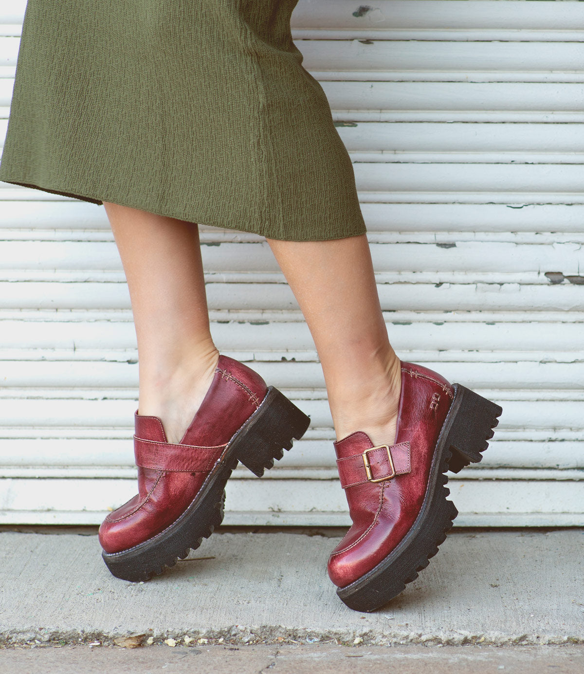 A woman wearing Bed Stu leather loafers.
