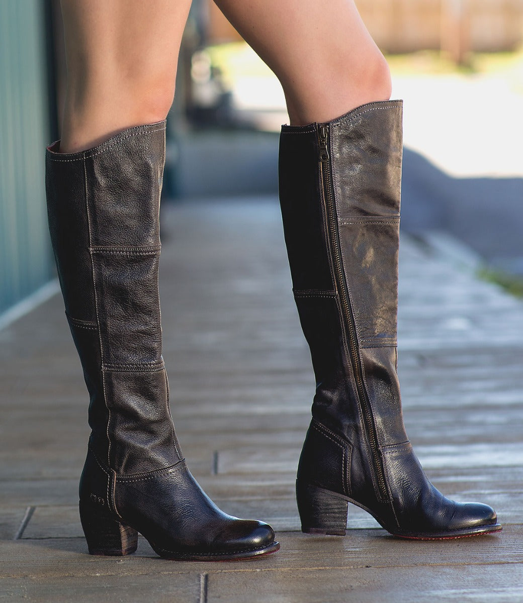 A woman in a pair of Bed Stu Kennice black leather boots.