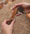 A person holding a Bed Stu Keygrab keychain and keys.