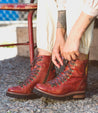 A woman wearing Khya boots by Bed Stu, made of pure leather with brown laces.