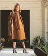 A woman in a tan coat wearing a Kiefra Trek boots by Bed Stu.