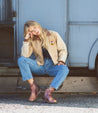 A woman in denim jeans and jacket wearing Kiefra Trek by Bed Stu.