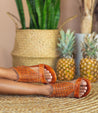 A woman wearing a pair of Bed Stu Kimberly leather woven sandals.