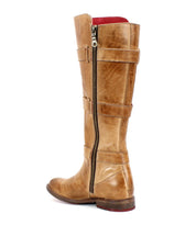 The Kitty boot by Bed Stu is a tall beauty, crafted in brown leather with adjustable straps, a side zipper, and buckle details.