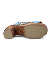 Bottom view of the Bed Stu Kreep sandal with a 70s-inspired design, featuring a blue upper, wooden platform heel, and light brown sole.