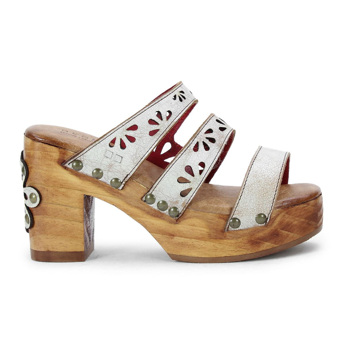 The Kreep by Bed Stu is a 70's-inspired wooden platform sandal with three white leather straps, featuring floral cutouts and metal studs.