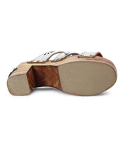 The bottom view features Bed Stu's Kreep sandal, inspired by the 70s, with a thick wooden heel and metal studs on the leather strap.