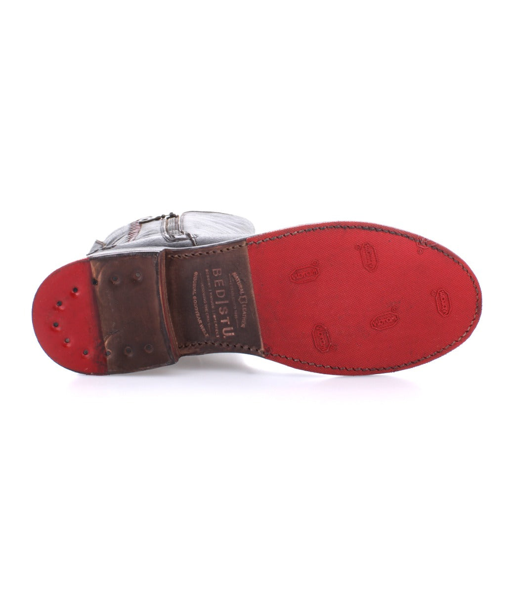 A pair of Latifah shoes by Bed Stu with a red sole and a silver buckle.