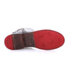 A pair of Latifah shoes by Bed Stu with a red sole and a silver buckle.