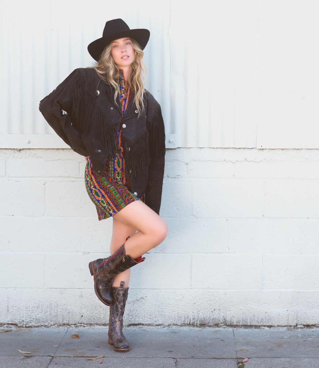 A woman wearing a pair of brown Bed Stu Latifah cowboy boots.