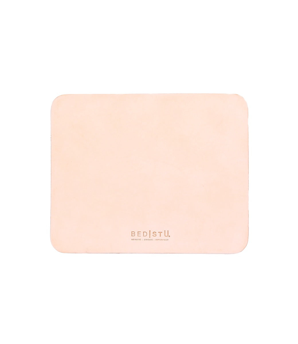 A pink leather Launcher mousepad on a white background by Bed Stu.