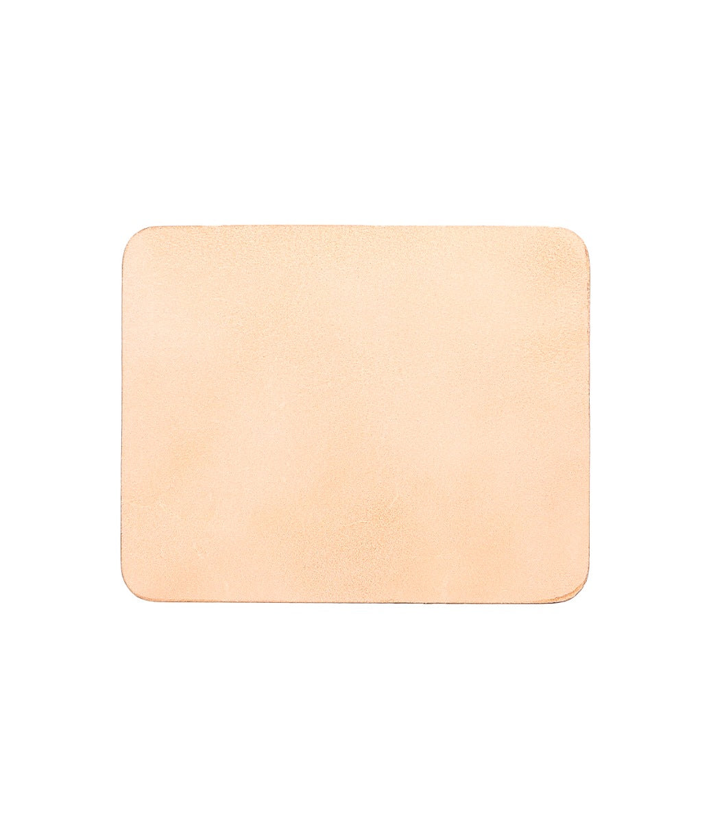 A Launcher Mouse Pad, rectangular, light tan-colored leather mouse pad with a suede underside and slightly rounded corners. Perfect for a curated workspace by Bed Stu.