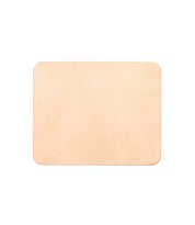 A Launcher Mouse Pad, rectangular, light tan-colored leather mouse pad with a suede underside and slightly rounded corners. Perfect for a curated workspace by Bed Stu.