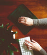 A woman's hands typing on a Bed Stu Launcher keyboard.