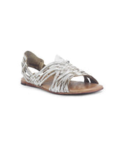 The Bed Stu Lauren II is a metallic silver huarache sandal with a hand-woven leather design, open toe, and flat sole.