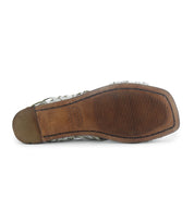 The Lauren II by Bed Stu showcases a bottom view of a square-toe huarache sandal. It features a brown sole with a textured grip pattern and is adorned with hand-woven leather for a unique design.