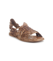 Displayed at an angle is the Lauren II by Bed Stu, a brown hand-woven leather huarache sandal featuring an open toe and slingback design.