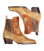 Introducing the League by Bed Stu: A pair of short brown leather Western boots adorned with decorative stitching and small metal studs. These stylish boots feature a ribbed ankle section and a wooden heel, perfect for a fashionable ride. Shown on a white background.