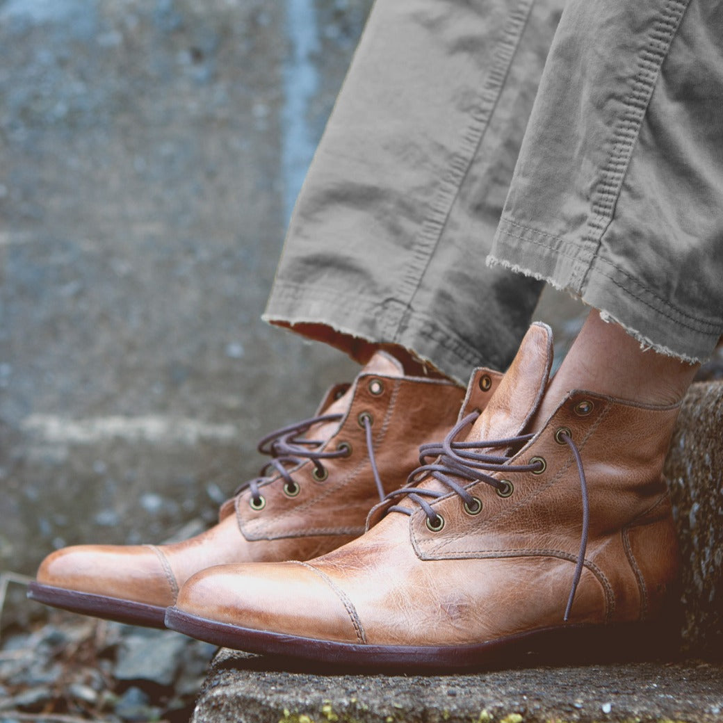 A man wearing a pair of Bed Stu Leonardo brown boots.