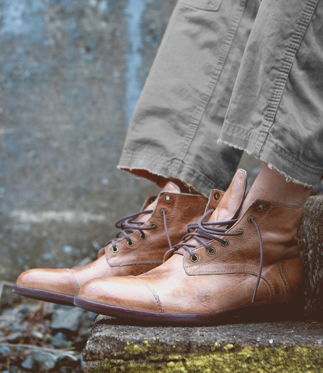 A man wearing a pair of Bed Stu Leonardo brown boots.
