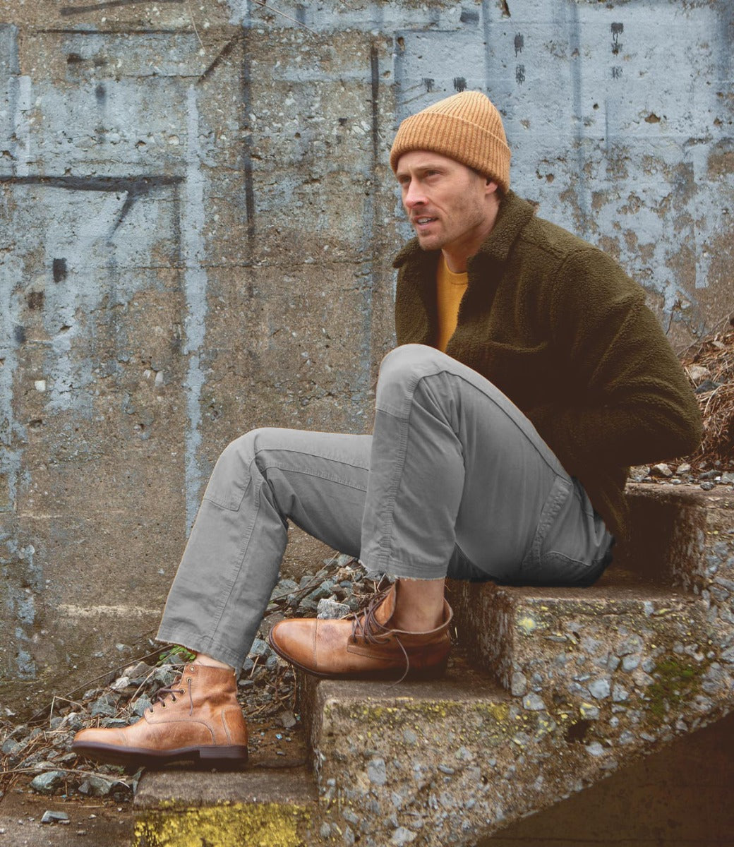 A man sitting on steps with a Bed Stu Leonardo beanie on his head.