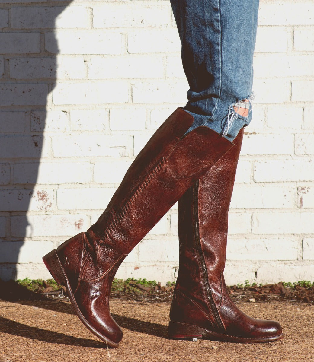 A woman wearing a pair of Bed Stu Letizia brown leather boots.