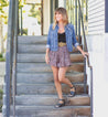 A woman wearing Lilia denim jacket and shorts on the stairs by Bed Stu.
