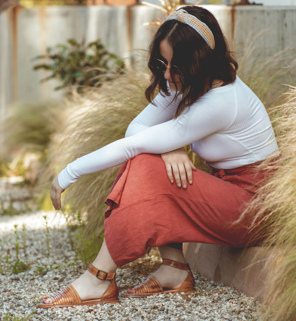 A woman wearing a Lilia shirt from Bed Stu and a red skirt.