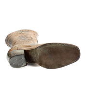 A single brown Western mid-calf boot from Bed Stu's Limit collection is shown from the bottom, highlighting its sole and heel, and adorned with delicate floral stitching.