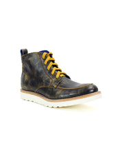 Classic work boot style meets modern flair in the Lincoln, a black leather ankle boot by Bed Stu. Featuring yellow laces and a white rubber sole, this men's leather boot is perfect for the casual male seeking durability and contemporary design.