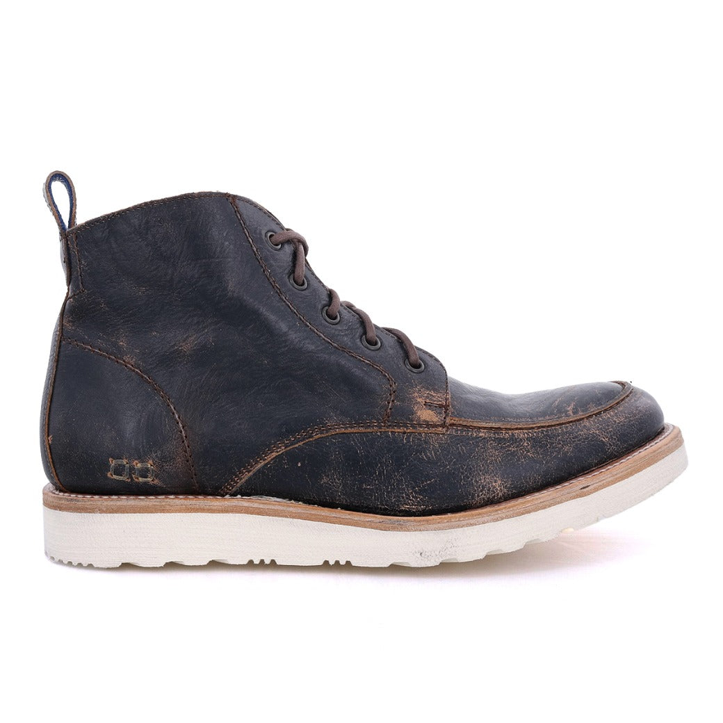 Side view of a worn, dark brown Bed Stu men's leather boot with laces and a white sole, isolated on a white background.