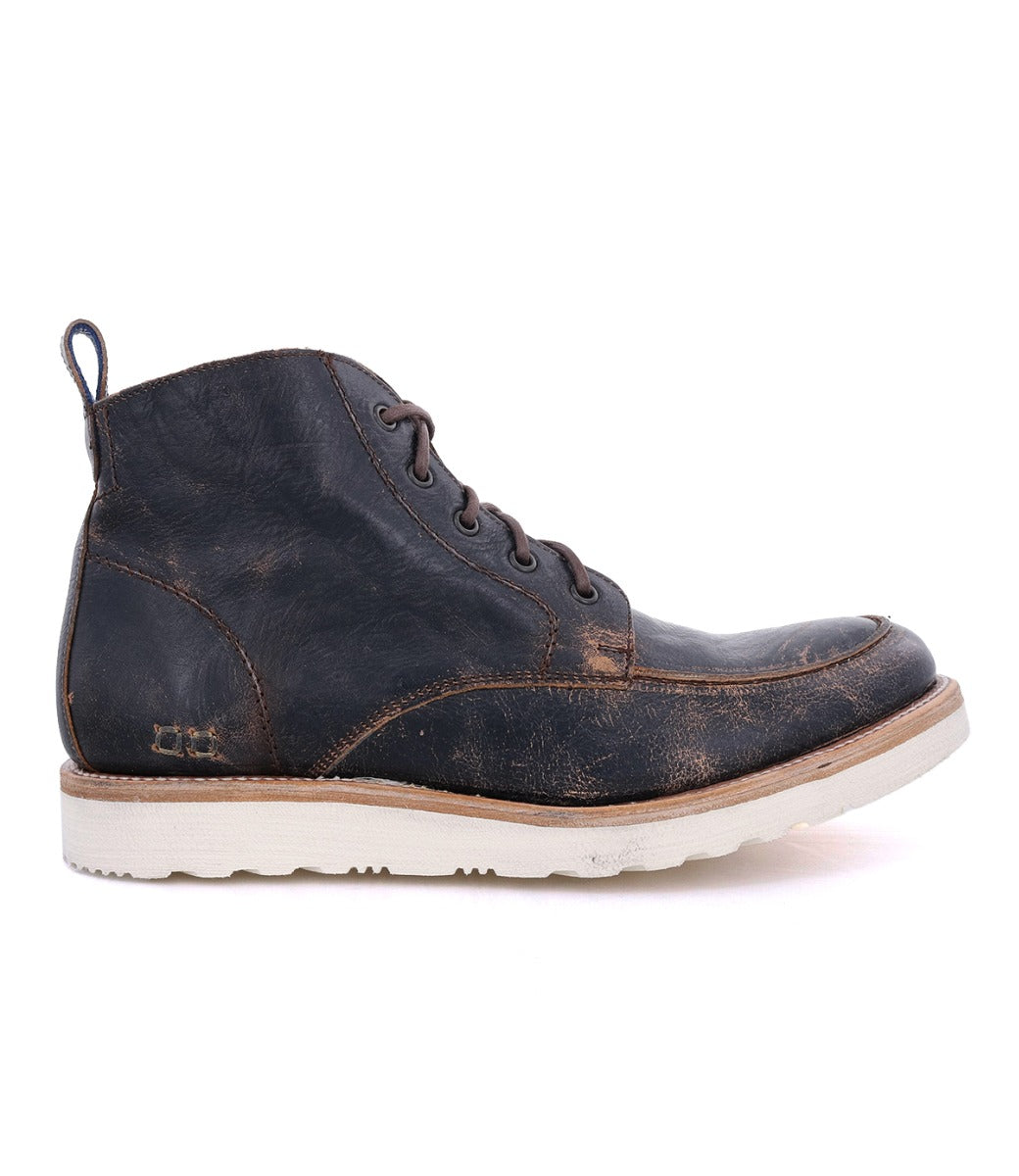 Side view of a worn, dark brown Bed Stu men's leather boot with laces and a white sole, isolated on a white background.