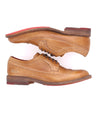 A pair of Bed Stu Lita K II shoes with red soles.