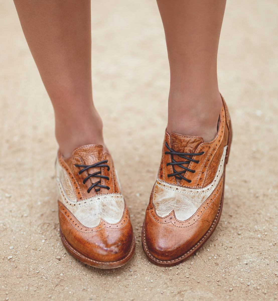 A woman wearing a pair of brown Bed Stu Lita oxford shoes.
