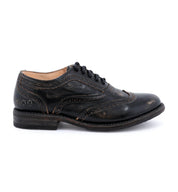A women's distressed black wingtip oxford shoe called "Lita" by Bed Stu.