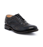 A women's distressed black wingtip oxford shoe called "Lita" by Bed Stu.