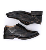 A pair of black Bed Stu Lita shoes on a white background.