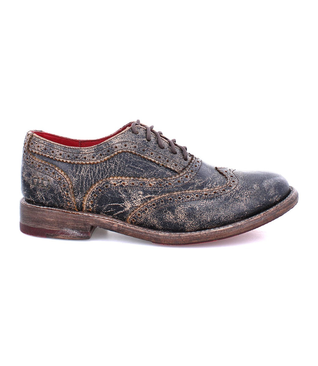 A women&#39;s distressed black wingtip oxford shoe called &quot;Lita&quot; by Bed Stu.
