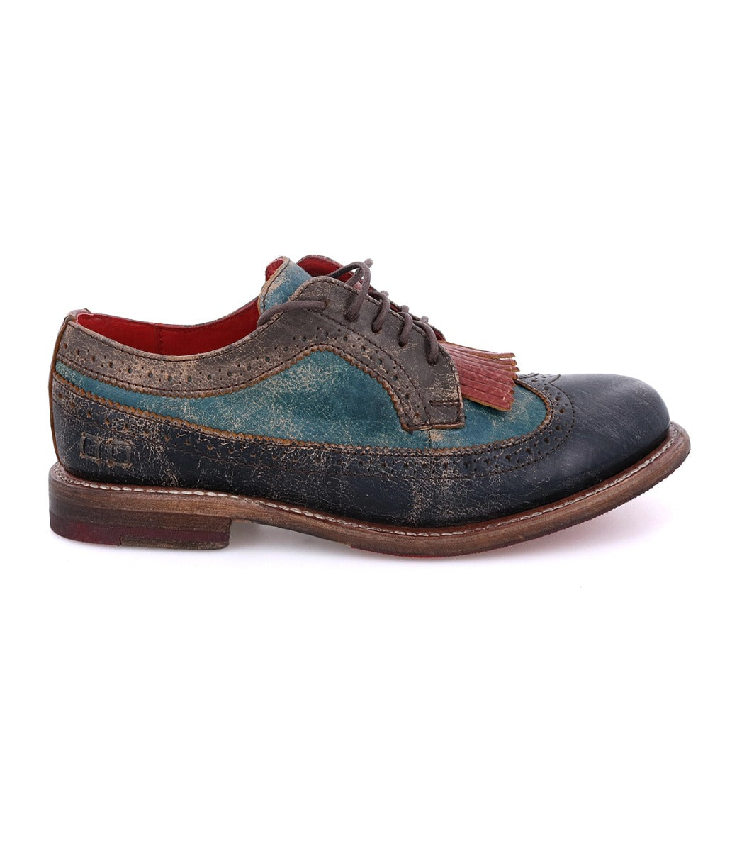 The Bed Stu Lita K is a multicolored leather brogue shoe with a wingtip toe, red inner lining, and decorative tassels, shown in profile on a white background.