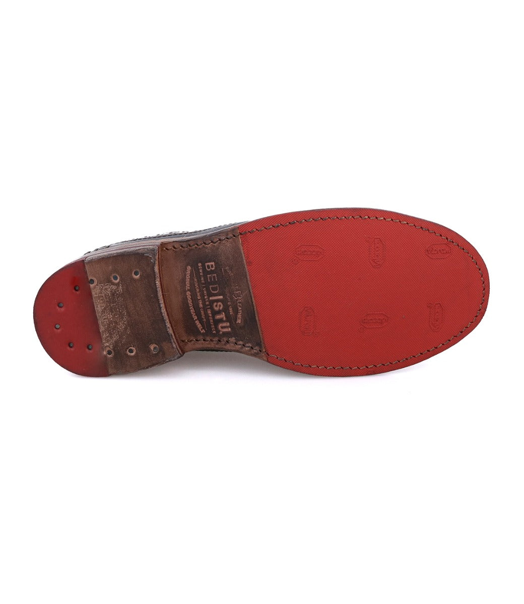 The underside of the Bed Stu Lita K classic derby shoe showcases a red leather sole with visible stitching, wingtip toe detail, and "Bed Stu" stamped on the arch.