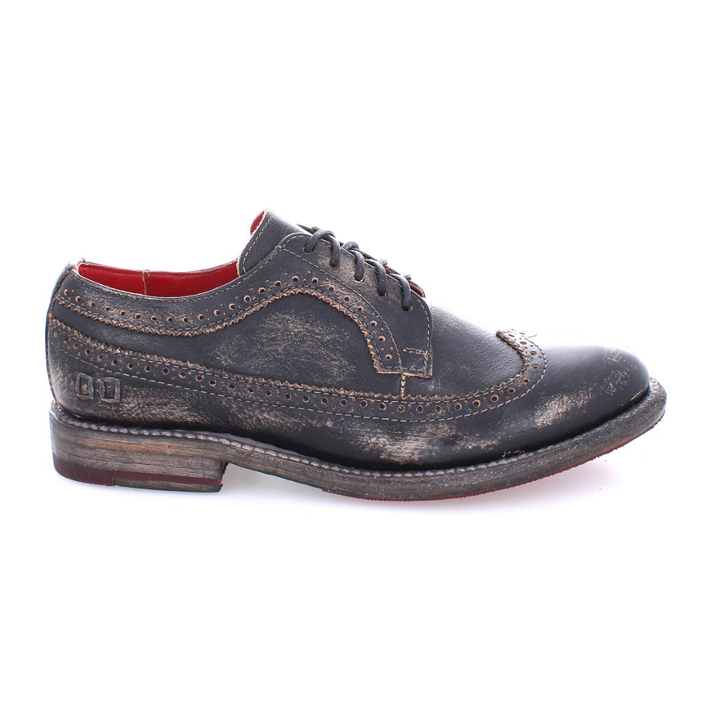 A women's black wingtip Oxford shoe with a red sole, the Bed Stu Lita K II.