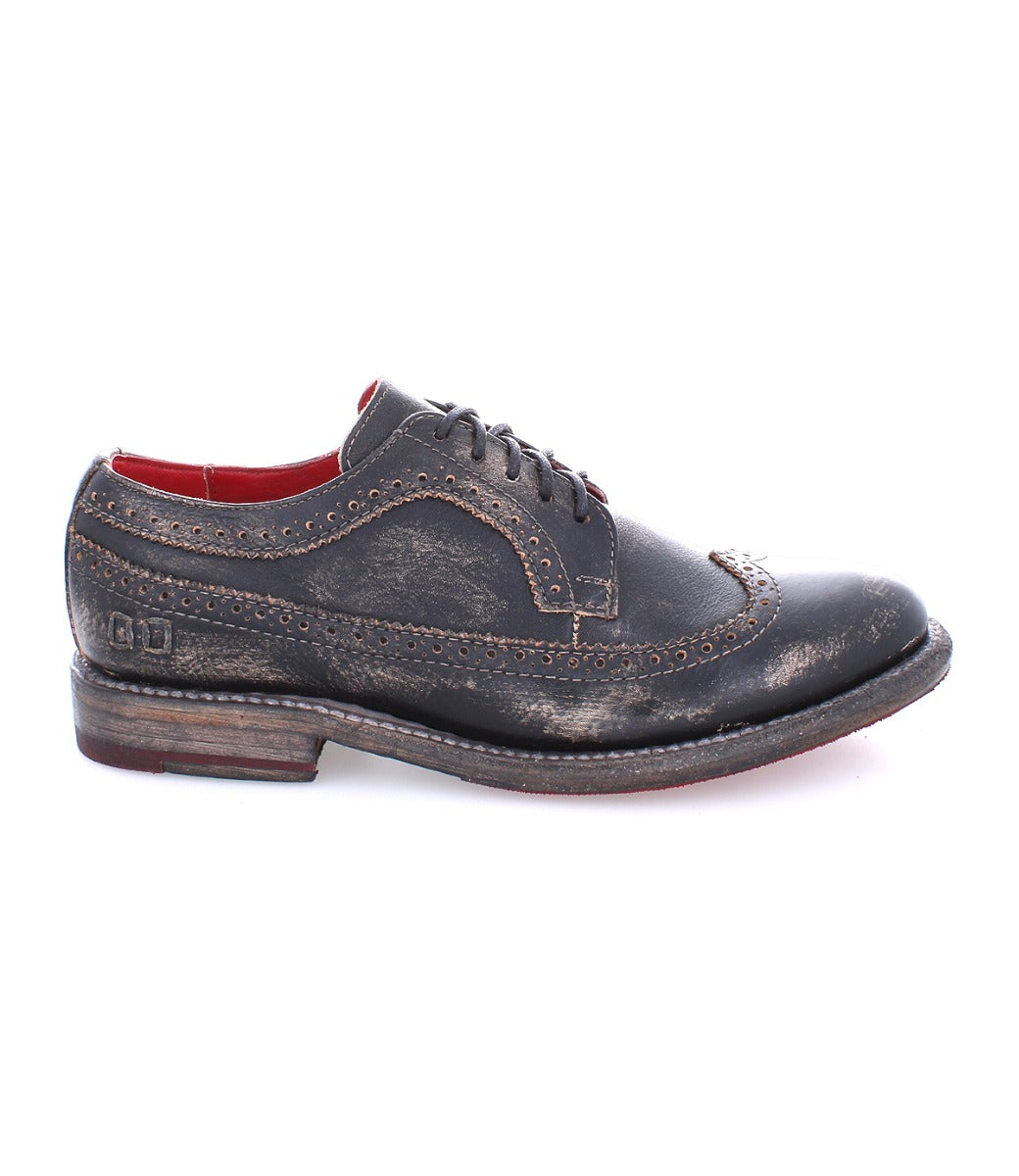 A women's black wingtip Oxford shoe with a red sole, the Bed Stu Lita K II.