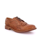 The Bed Stu Lita K is a classic brown leather derby shoe with wingtip toe, brogue details, dark laces, and a removable kiltie fringe, shown against a white background.
