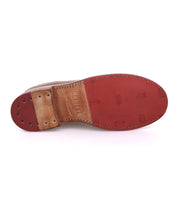 The Lita K by Bed Stu is a classic derby shoe in brown leather with a red tread sole, visible stitching, and branded detail near the arch.