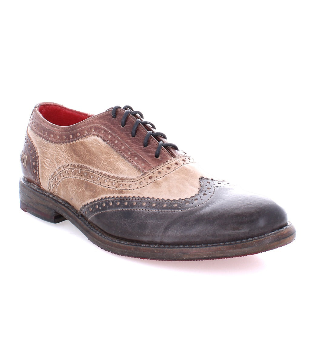 A woman's wingtip oxford shoe, the Lita by Bed Stu, with brown and black detailing.