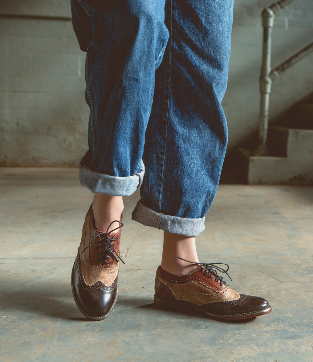 A person wearing jeans and a pair of Bed Stu Lita shoes.