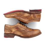 A pair of Bed Stu Lita tan shoes with red soles.